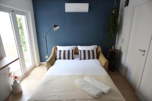 Кровать или кровати в номере Casa Glória
