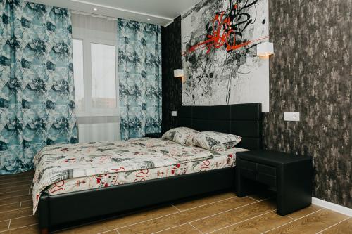 a small bedroom with a bed and a window at Luxury Apartment in Sumy