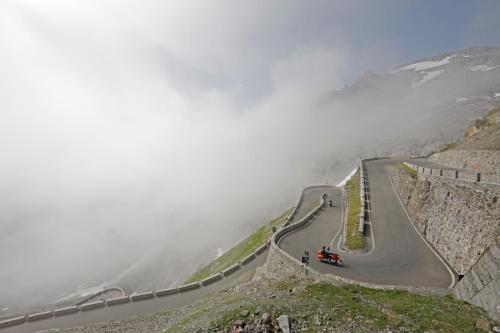 a road on the side of a mountain in the clouds at Pension & Residence Astoria in Prato allo Stelvio