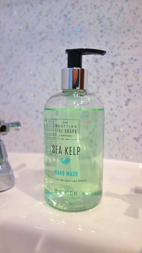 a bottle of sea kelp soap sitting on a bathroom sink at Bunroy Park in Fort William