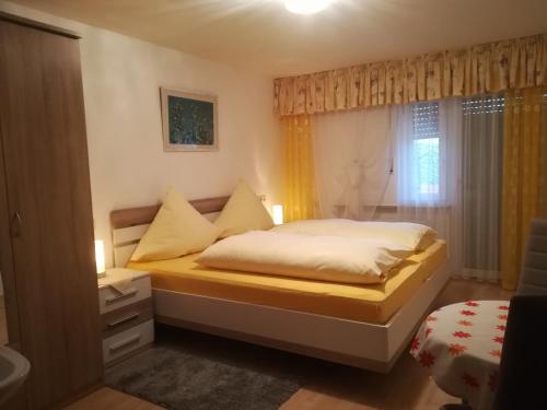 a bedroom with a bed and a window at Landhaus Irma in Bad Füssing