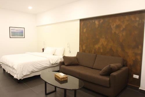 a bedroom with a bed and a couch and a bed at Hamra Urban Gardens in Beirut