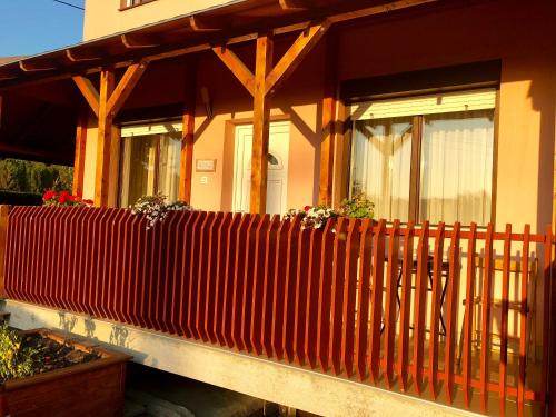 a house with a red fence in front of it at RT Home Vendégház in Szombathely