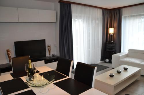 a living room with a dining table and a couch at Vakantiehuis Jonckershof in Middelkerke