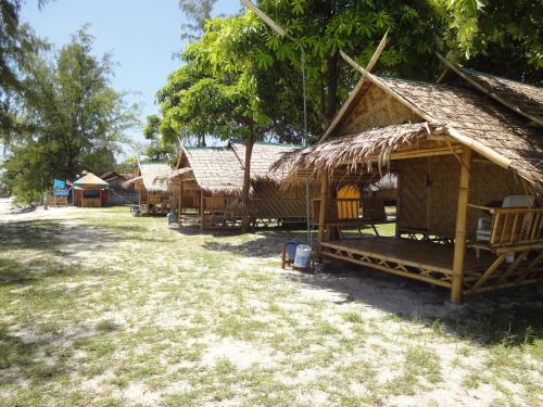a group of huts are lined up in a field at Varin Village Koh Lipe in Ko Lipe