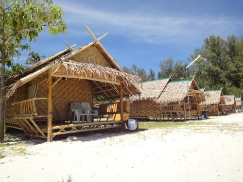 a group of huts on the beach at Varin Village Koh Lipe in Ko Lipe