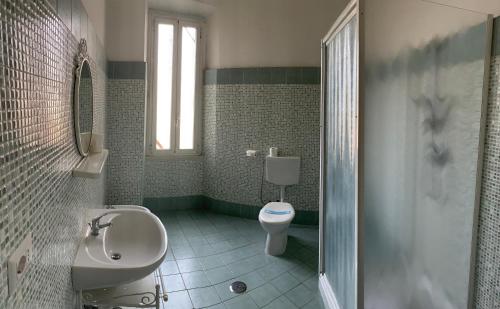 a bathroom with a sink and a toilet and a shower at Amico Hotel in Rome