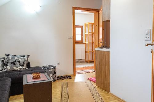 a living room with a couch and a table at Apartments In in Jahorina