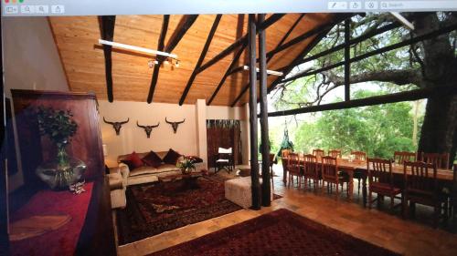 a large living room with a table and chairs at Msunduze River Lodge in Mkuze