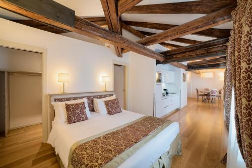 a hotel room with a large bed and a large window at Al Redentore Di Venezia in Venice