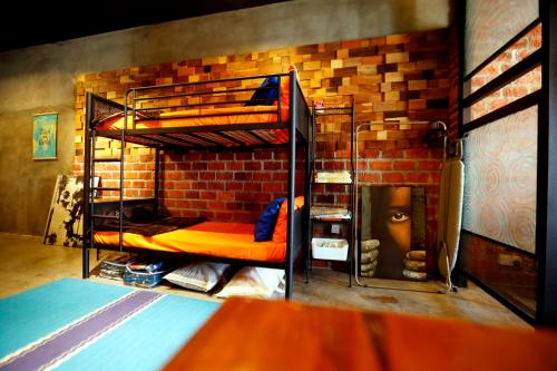 een kamer met 2 stapelbedden in een bakstenen muur bij Homestay Shah Alam by Rose - Studio Unit in Shah Alam