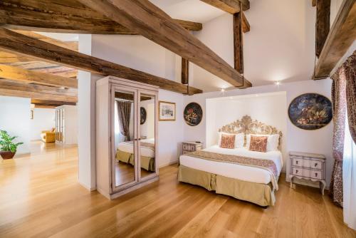 a bedroom with two beds and wooden ceilings at Al Redentore Di Venezia in Venice