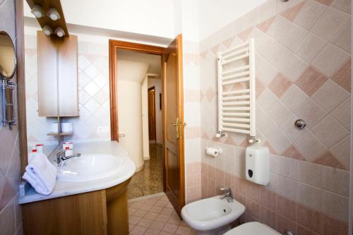 a bathroom with a sink and a toilet at Via Curtatone 12 Stazione Termini in Rome