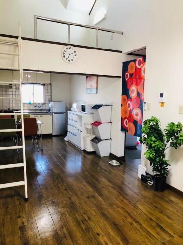 an office with a desk and a clock on the wall at 201Keiko's Home 大空間2LDKロフト付きfree parking in Kasugabaru