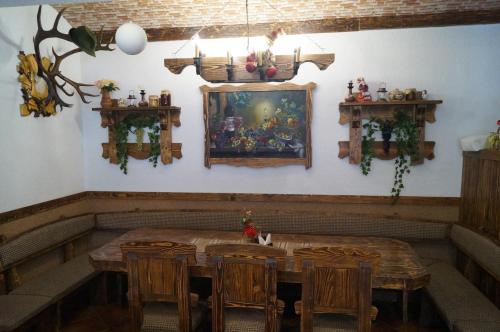 a dining room with a wooden table and chairs at Panorama Yasinya in Yasinya