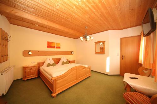 a bedroom with a bed and a wooden ceiling at Aignerhof in Haus im Ennstal