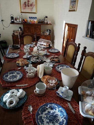 a dining room table with blue and white dishes on it at Gianmaria B&B in Tricarico