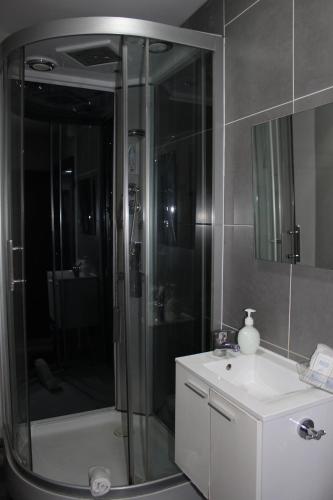 a bathroom with a shower and a sink and a toilet at BCN Condal Hostal in Barcelona