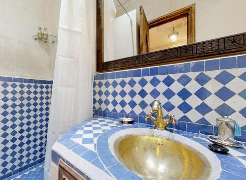 a bathroom with a sink and a mirror at Riad Sania By Ghali in Marrakech