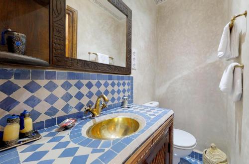 a bathroom with a sink and a mirror at Riad Sania By Ghali in Marrakech