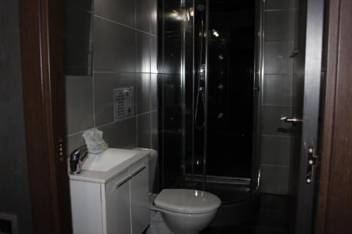 a bathroom with a shower and a toilet and a sink at BCN Condal Hostal in Barcelona