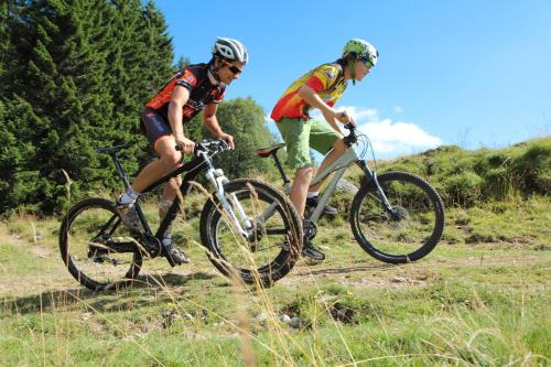 two people riding bikes on a dirt trail at Azureva Murol in Murol