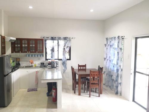 a kitchen with a table and chairs in it at MoonViews Apartment in Panglao