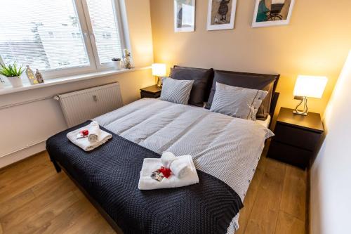 - une chambre avec un grand lit et des serviettes dans l'établissement apartmán v srdci Českého ráje, à Jičín
