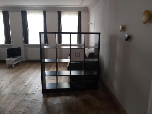 a room with a glass shelf in the middle of a room at The Court House in Bressanone