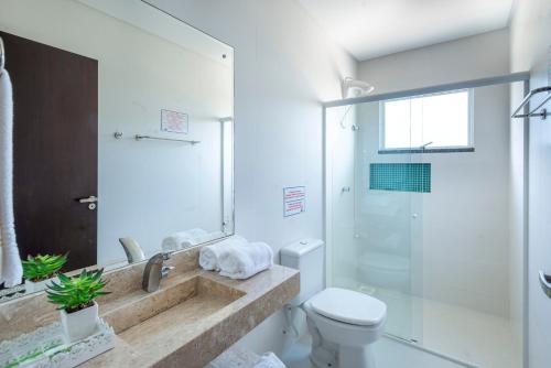 a bathroom with a sink and a toilet and a shower at Residencial Onda Azul in Bombinhas