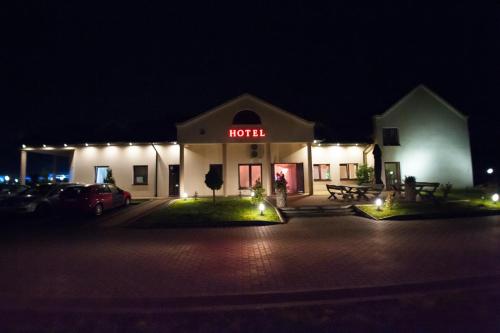 a hotel at night with a sign that reads hotel at Hotel Graal Targowisko in Targowisko