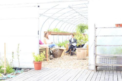 a group of people sitting in a greenhouse at Móðir Jörð Organic B&B in Vallanes in Vallanes