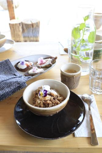 a bowl of food on a plate on a table at Móðir Jörð Organic B&B in Vallanes in Vallanes