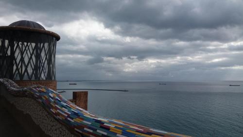 a hammock on a balcony looking at the water at Casa Panorama Amalfi Coast in Vietri sul Mare
