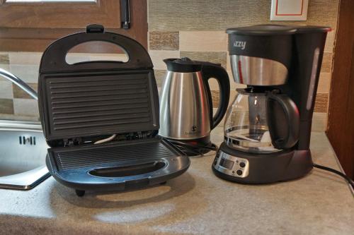 a black blender sitting on top of a counter at Ktima Kiourelioti in Skála Sykaminéas