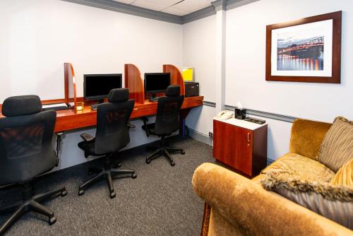 an office with a desk with two monitors and a couch at New Hope Inn & Suites in New Hope