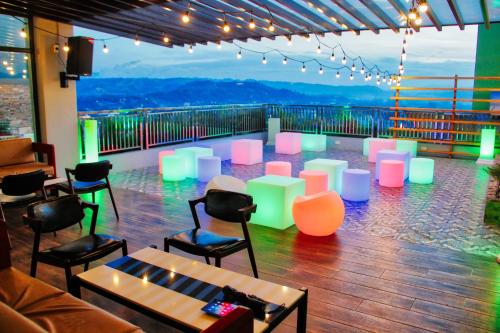 a room with chairs and tables with a view at New Dawn Hotel Plus in Cagayan de Oro