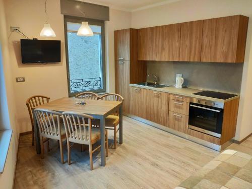 a kitchen with a table and chairs and a television at Kriemhilde Dependance in Worms
