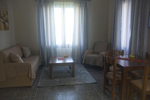 a living room with a couch and a table at Ktima Kiourelioti in Skála Sykaminéas