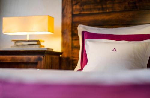 a bed with a pillow with a small tree on it at Waldhaus Ohlenbach in Schmallenberg