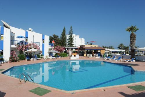 a large swimming pool in the middle of a hotel at Alexia Hotel Apartments in Ayia Napa