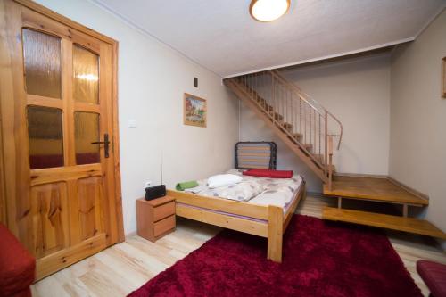 a bedroom with a bunk bed and a staircase at Domek na Kaszubach - Cały dla Ciebie! in Lipnica