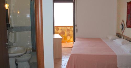 a bedroom with a bed and a bathroom with a shower at Hotel Diana in Ustica