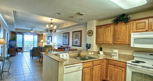 a kitchen with wooden cabinets and a counter top at Penthouse Close to Disney area and Malls water view in Orlando