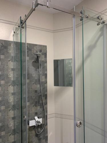 a shower with a glass door in a bathroom at Self-Check Apartment Lilia 2 next to 24 hours open food and drink shop and free parking area in Sofia