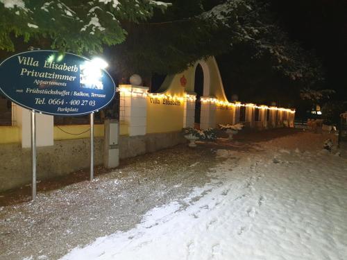a sign in front of a building at night at Villa Elisabeth in Admont