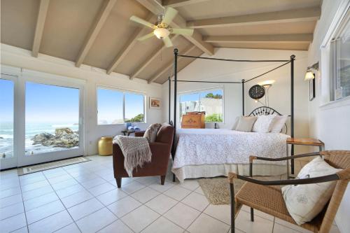 a bedroom with a bed and views of the ocean at Marebello in Fort Bragg