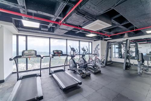 a gym with two treadmills and bikes in it at Hotel Mocawa Plaza Armenia in Armenia