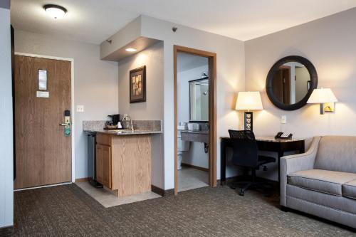 a hotel room with a desk and a chair at Heartland Inn Coralville in Coralville