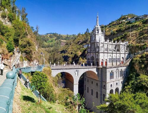 a castle on a bridge with people standing on it at Hotel Casa de Peregrinos in Ipiales